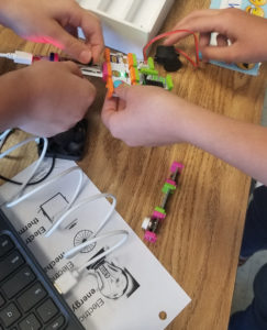 Hands working together with littleBits. 