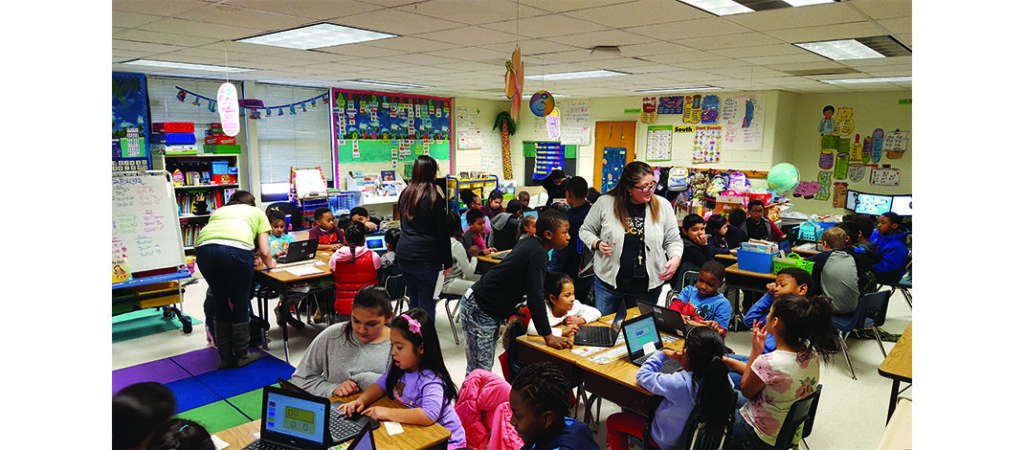Classroom full of students working collaboratively.